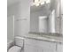 Bathroom vanity with granite-look countertop, white cabinets, and a large mirror at 7238 Crestside Dr, Austell, GA 30168