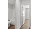 A half-view of a bathroom with white fixtures and wood-look flooring at 7238 Crestside Dr, Austell, GA 30168
