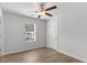 Bedroom featuring light gray walls, wood-look floors, ceiling fan, and a window at 7238 Crestside Dr, Austell, GA 30168