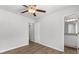 Bedroom with light gray walls, wood-look floors, ceiling fan, and bathroom access at 7238 Crestside Dr, Austell, GA 30168