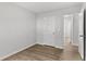 A bright bedroom with light gray walls, wood-look floors, and white trim at 7238 Crestside Dr, Austell, GA 30168
