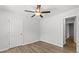 Bedroom featuring light gray walls, wood-look floors, and a ceiling fan at 7238 Crestside Dr, Austell, GA 30168
