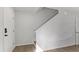 Hallway featuring stairs, hardwood floors, and white painted walls at 7238 Crestside Dr, Austell, GA 30168