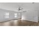 Bright living room with hardwood floors, large windows, and a ceiling fan at 7238 Crestside Dr, Austell, GA 30168