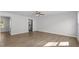 Open-concept living room with hardwood floors, neutral walls, and ceiling fan at 7238 Crestside Dr, Austell, GA 30168
