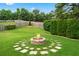 Private backyard oasis with lush greenery and a stone fire pit, perfect for outdoor gatherings and relaxation at 910 Laurel Cove Dr, Snellville, GA 30078