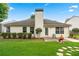 Home featuring a backyard with lush green grass, mature trees, and a patio with a seating area at 910 Laurel Cove Dr, Snellville, GA 30078
