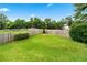 A lush, green backyard with a well-maintained lawn and a classic wooden fence for privacy at 910 Laurel Cove Dr, Snellville, GA 30078