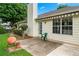 The home features a backyard patio with a green chair, lush trees and a charming terracotta pot at 910 Laurel Cove Dr, Snellville, GA 30078