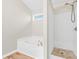Bathroom features a jetted tub and separate shower at 910 Laurel Cove Dr, Snellville, GA 30078
