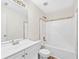 Clean and functional bathroom with a shower-tub combination, vanity sink, and neutral tile accents at 910 Laurel Cove Dr, Snellville, GA 30078
