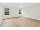 Spacious main bedroom with tray ceiling, ceiling fan, and two large windows at 910 Laurel Cove Dr, Snellville, GA 30078
