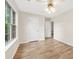 Charming bedroom featuring hardwood floors, two doors, a ceiling fan, and a window overlooking the outdoors at 910 Laurel Cove Dr, Snellville, GA 30078