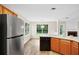Eat-in kitchen has stainless steel appliances, wood cabinets and an adjacent dining area at 910 Laurel Cove Dr, Snellville, GA 30078