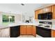 Bright kitchen with a view to a backyard and open to an adjacent living room at 910 Laurel Cove Dr, Snellville, GA 30078