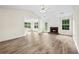 Bright living space with a fireplace, hardwood floors, and a view of the backyard at 910 Laurel Cove Dr, Snellville, GA 30078