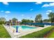Community pool with ample lounge chairs, umbrellas, and a nearby clubhouse for residents' enjoyment at 910 Laurel Cove Dr, Snellville, GA 30078