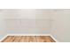 Spacious walk-in closet with wooden floors and white wire rack shelving for maximum storage and organization at 910 Laurel Cove Dr, Snellville, GA 30078
