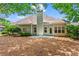 Private backyard with a patio area surrounded by mature trees at 115 Graystone Terrace Ter, Alpharetta, GA 30005