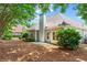 Spacious backyard featuring lush greenery, a patio area, and a secure fence at 115 Graystone Terrace Ter, Alpharetta, GA 30005
