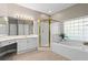 Luxurious bathroom featuring a soaking tub, walk-in shower, and vanity with ample counter space at 115 Graystone Terrace Ter, Alpharetta, GA 30005