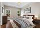 Serene bedroom showcasing a tray ceiling, natural light, and calming decor at 115 Graystone Terrace Ter, Alpharetta, GA 30005