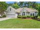 Charming single-story home with lush green lawn and well-maintained landscaping at 115 Graystone Terrace Ter, Alpharetta, GA 30005