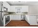 Modern kitchen featuring stainless steel appliances, white cabinetry, and granite countertops at 115 Graystone Terrace Ter, Alpharetta, GA 30005