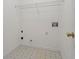 A bright laundry room with a wire shelf, utility connections, and tile flooring at 115 Graystone Terrace Ter, Alpharetta, GA 30005