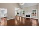 Open-concept living room boasting hardwood floors, natural light, and a cozy fireplace at 115 Graystone Terrace Ter, Alpharetta, GA 30005