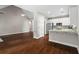 Open floor plan with hardwood floors connecting the living room and kitchen area at 115 Graystone Terrace Ter, Alpharetta, GA 30005