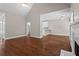 Open concept living room with hardwood floors flowing into the kitchen area at 115 Graystone Terrace Ter, Alpharetta, GA 30005
