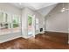 Bright living room with hardwood floors, fireplace, and French doors leading to the outside at 115 Graystone Terrace Ter, Alpharetta, GA 30005