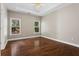 Bright bedroom with hardwood floors and large windows overlooking the backyard at 115 Graystone Terrace Ter, Alpharetta, GA 30005