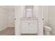 En-suite bathroom featuring vanity, tile floors, and a toilet next to closet space at 3182 Hartford Mill Pl, Duluth, GA 30097