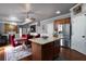 Eat-in kitchen with wood cabinets, stainless appliances, and central island open to living area at 3770 Falling Leaf Ln, Cumming, GA 30041