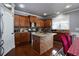 Bright kitchen with wood cabinets, granite countertops, stainless appliances, and island with seating at 3770 Falling Leaf Ln, Cumming, GA 30041