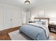 Bedroom featuring hardwood floors, neutral colored walls, and a blue accent duvet at 55 Cooper Lake Rd, Mableton, GA 30126