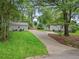 Long driveway leads to a charming home with lush green landscaping and a guest house at 55 Cooper Lake Rd, Mableton, GA 30126