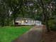Charming home with a covered porch, walkway, detached garage, and curb appeal at 55 Cooper Lake Rd, Mableton, GA 30126