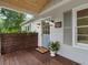 Inviting front entrance featuring a stylish blue door, classic lighting, and a 'Welcome' mat on a wooden deck at 55 Cooper Lake Rd, Mableton, GA 30126