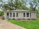 Charming home featuring bay windows and newly landscaped lawn with a concrete walkway at 55 Cooper Lake Rd, Mableton, GA 30126
