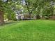 Beautiful home with lush landscaping, mature trees, and a well-manicured lawn at 55 Cooper Lake Rd, Mableton, GA 30126