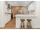 Modern kitchen with stainless steel appliances, sleek countertops, breakfast bar, and a combination of white and wood cabinets at 55 Cooper Lake Rd, Mableton, GA 30126