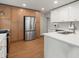 Modern kitchen featuring stainless steel appliances, a breakfast bar, and a combination of white and wood cabinets at 55 Cooper Lake Rd, Mableton, GA 30126