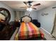 Cozy bedroom with a ceiling fan and ornate wood furniture at 726 Shoreline Se Trl, Conyers, GA 30094