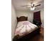 Comfortable bedroom with wood frame bed, ceiling fan, and desk area at 726 Shoreline Se Trl, Conyers, GA 30094