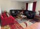 Spacious living room with a sectional sofa, decorative rug, and natural light at 726 Shoreline Se Trl, Conyers, GA 30094