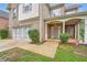 Inviting home with a two-car garage, covered porch, and well-kept lawn at 909 Pine Cove Dr, Lilburn, GA 30047