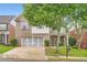 Charming brick home with a two-car garage, well-manicured lawn and mature trees providing shade at 909 Pine Cove Dr, Lilburn, GA 30047